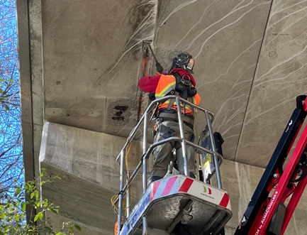 man working under bridge